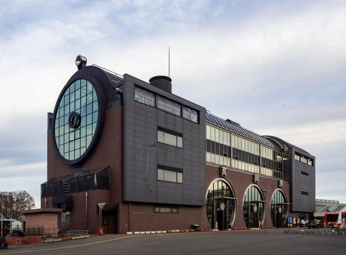 Unusual building with a large circular window and industrial design elements