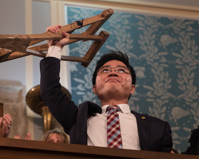 A man holding up a wooden frame during a speech concerning Kim Jong Un passing away rumors. A man holding up a wooden frame during a speech concerning Kim Jong Un passing away rumors.