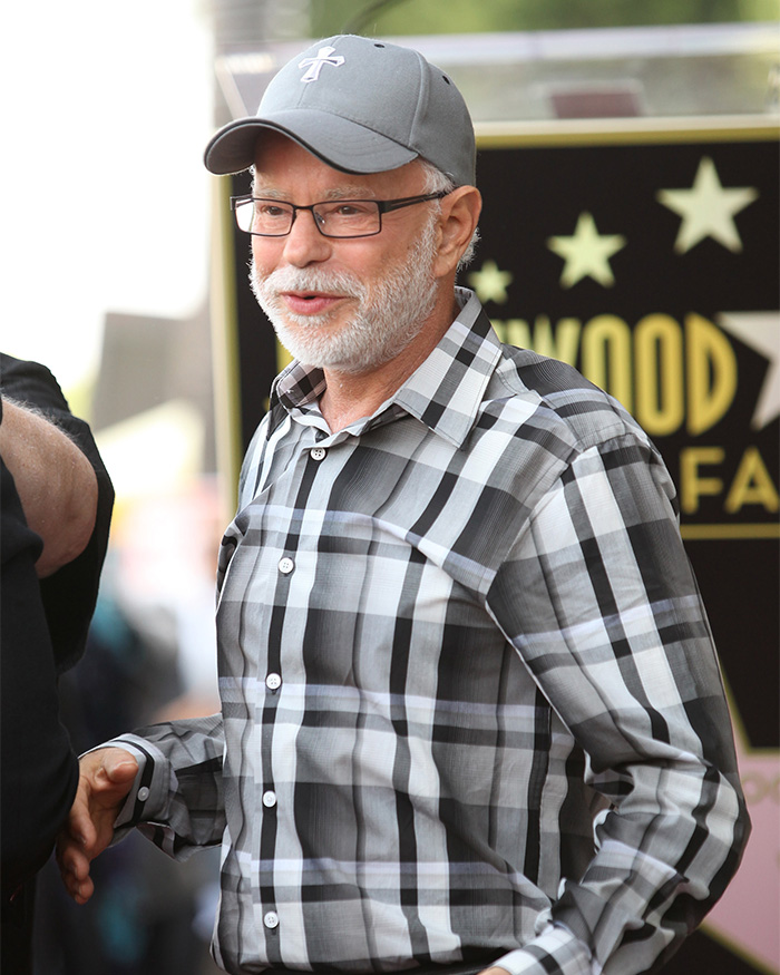 Televangelist Jim Bakker wearing a cross cap, representing his religious career Televangelist Jim Bakker wearing a cross cap, representing his religious career