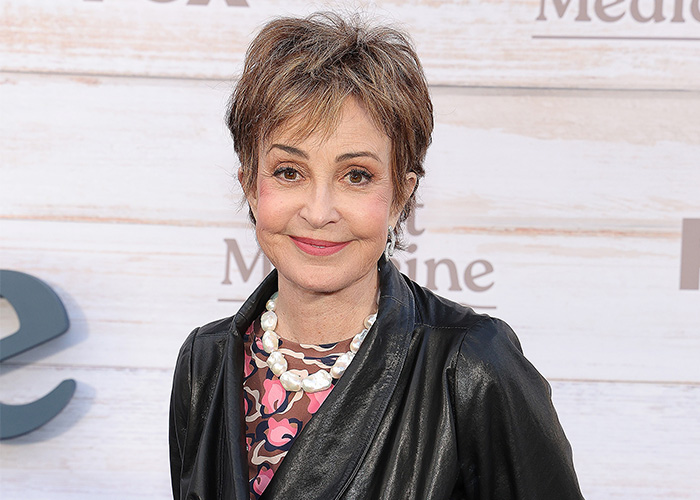 Young Sheldon actress Annie Potts smiling at a red carpet event. Young Sheldon actress Annie Potts smiling at a red carpet event.