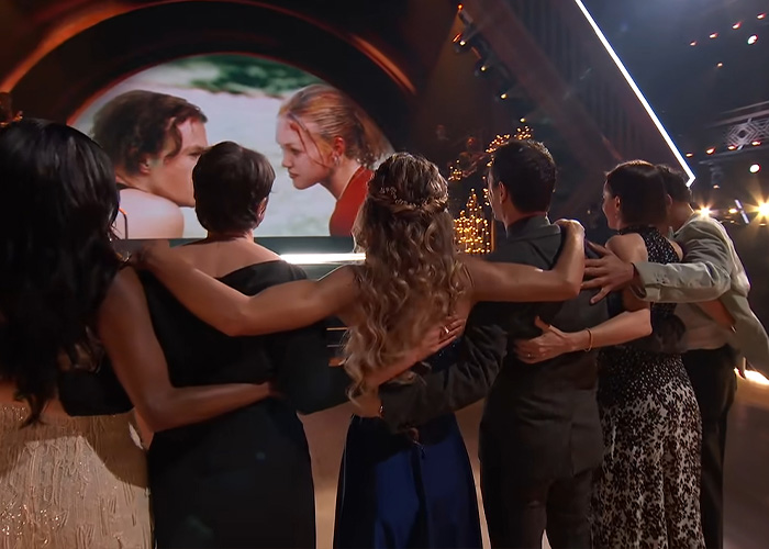 Cast members watch a tribute on a screen, after a Hollywood actress faced backlash for her late co-star honor.