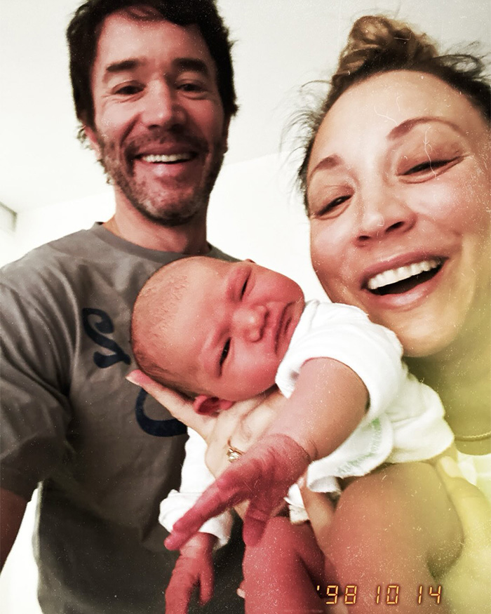 Happy couple holding newborn baby after birth reveals baby name Happy couple holding newborn baby after birth reveals baby name