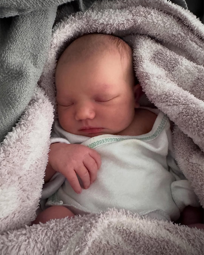Sleeping newborn baby wrapped in blanket after birth announcement Sleeping newborn baby wrapped in blanket after birth announcement