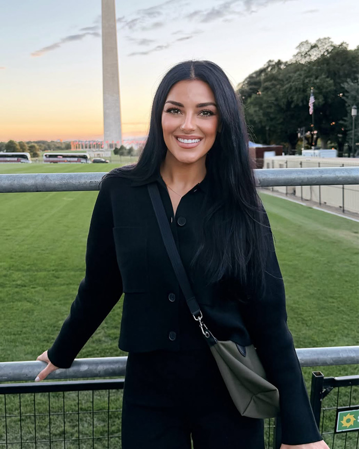 Kash Patel fiance&eacute; smiling in front of the Washington Monument
