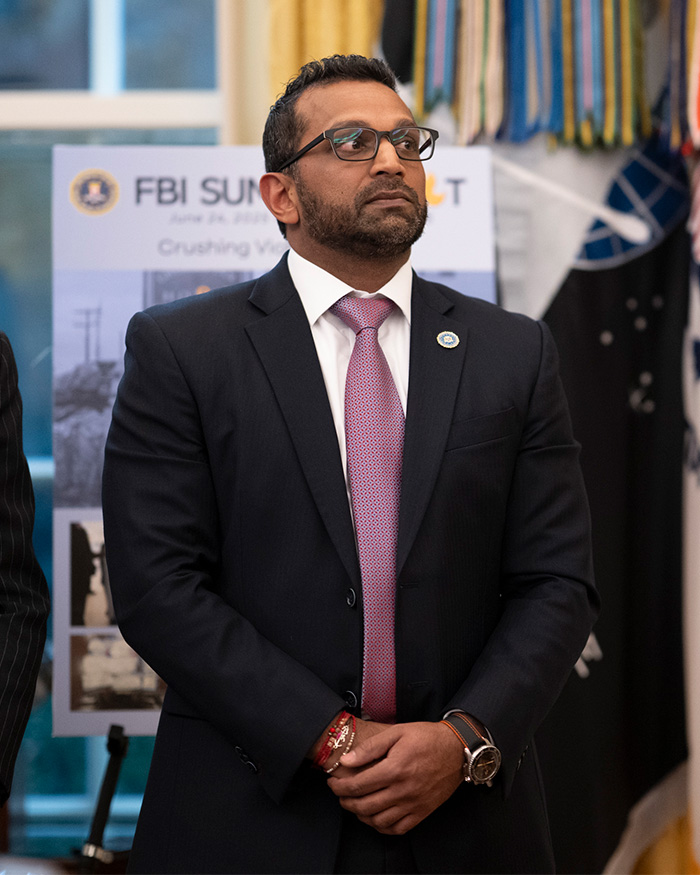 A close-up of Kash Patel in a suit and tie looking off-camera