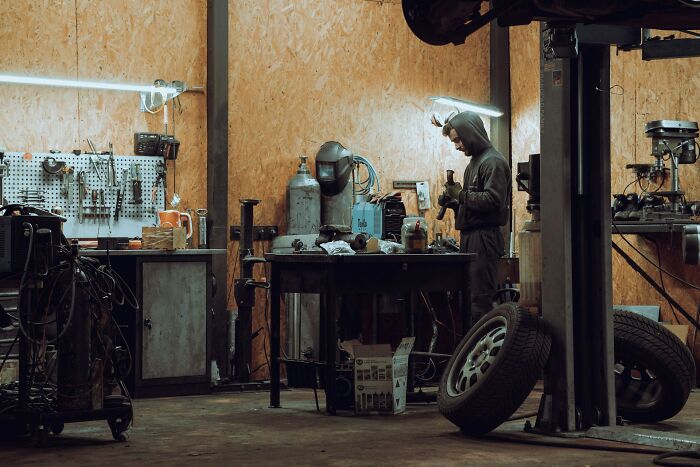 A mechanic working in an auto repair shop, relating to cruel infidelity stories and unexpected discoveries.