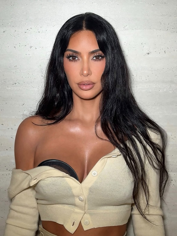 Close-up portrait of Kim Kardashian wearing a beige cardigan Close-up portrait of Kim Kardashian wearing a beige cardigan