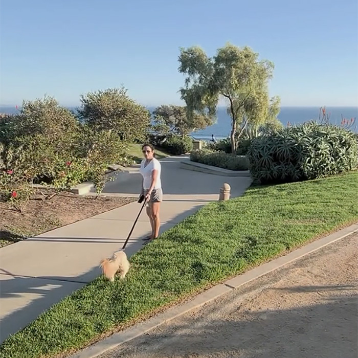 A woman walking her dog near a romantic proposal spot in Laguna Beach A woman walking her dog near a romantic proposal spot in Laguna Beach