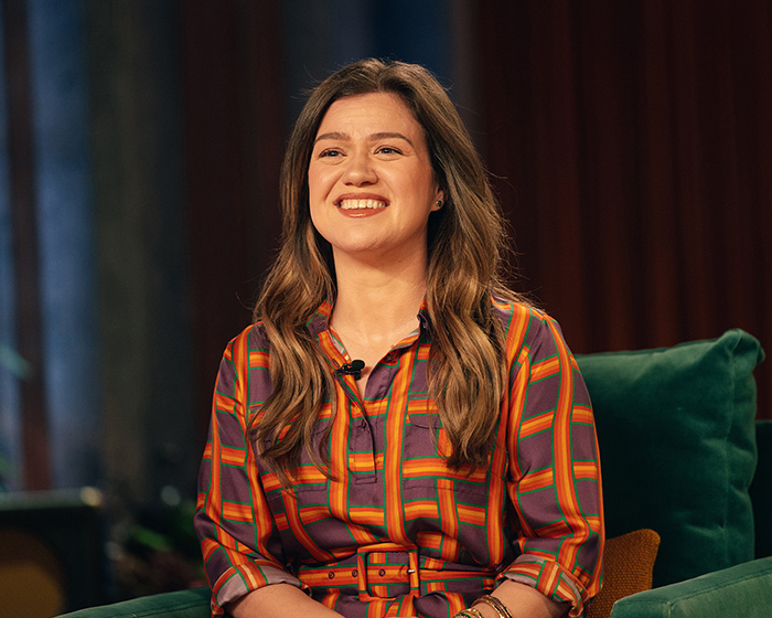 Kelly Clarkson smiling during a television interview indoors
