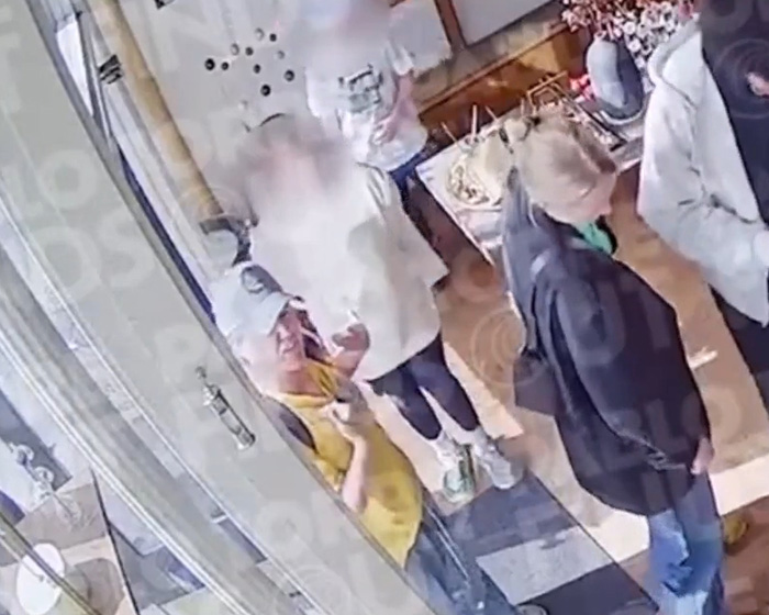 Security footage capture of people interacting inside Brooklyn shop