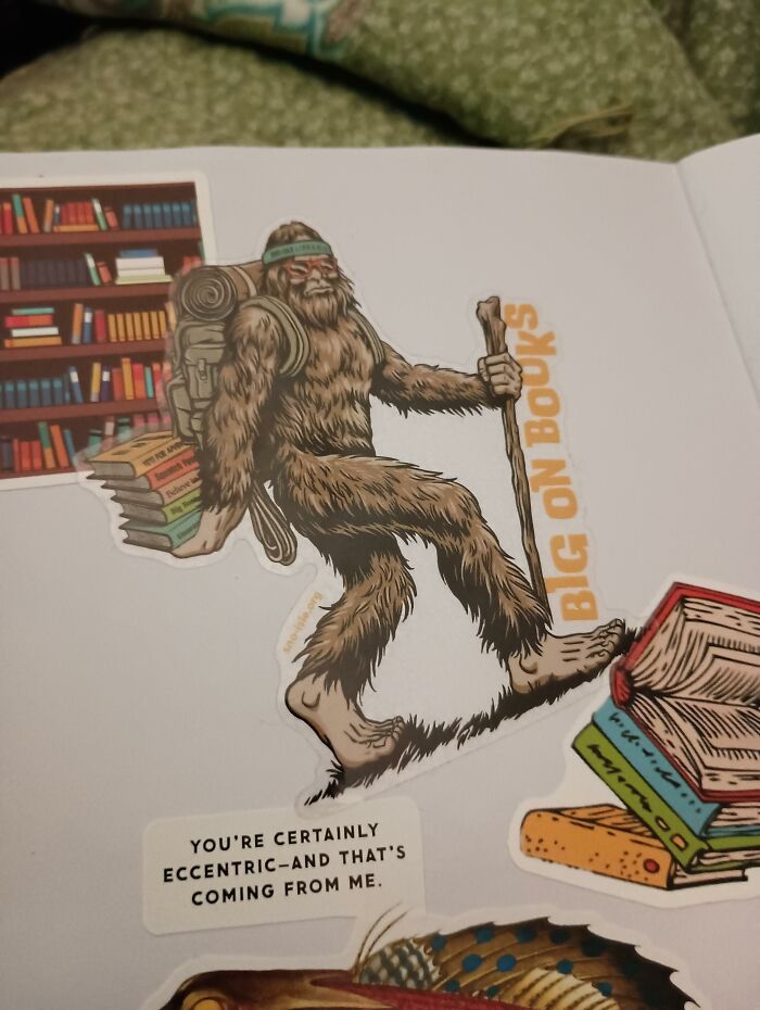 A Bigfoot sticker holding a stack of books on a journal page representing a unique found paper note.