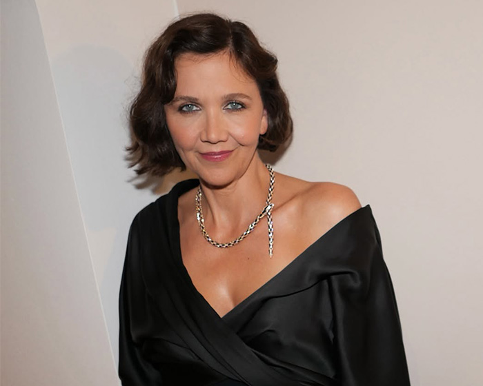 Hollywood actress Maggie Gyllenhaal wearing an off-the-shoulder black dress and necklace.