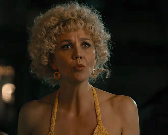 Hollywood actress Maggie Gyllenhaal portraying a character on set in a movie scene.