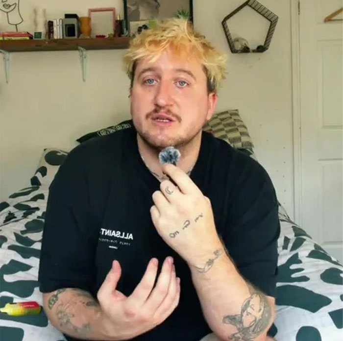 Man explaining debt payoff strategy in room with tattoos visible