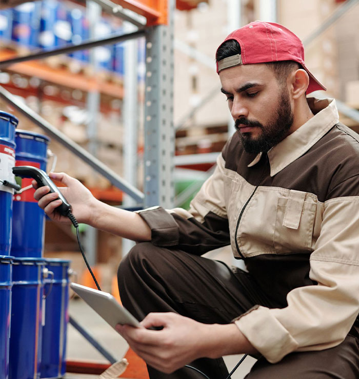 Worker checking inventory with tablet in warehouse