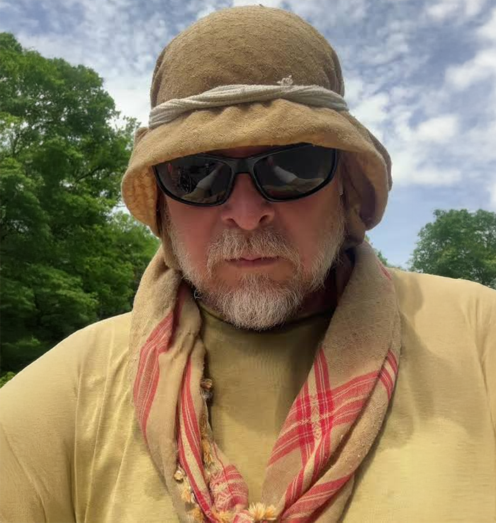 Karl Bushby, the man who goes for a walk in 1998, wearing a desert hat, sunglasses, and a scarf. Karl Bushby, the man who goes for a walk in 1998, wearing a desert hat, sunglasses, and a scarf.