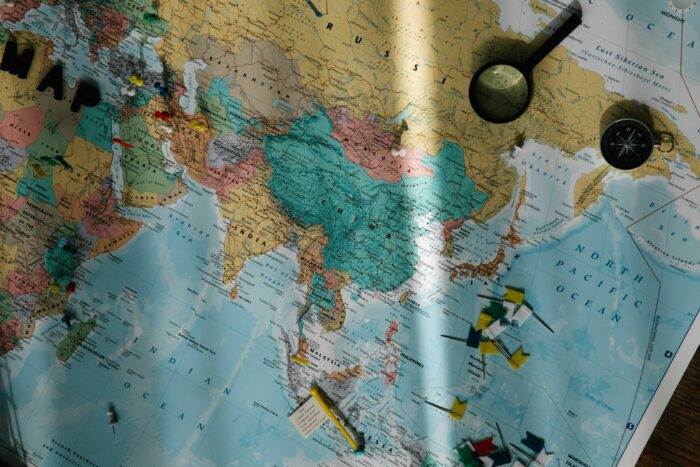 A colorful world map with pins, planning a long walk across countries. A colorful world map with pins, planning a long walk across countries.