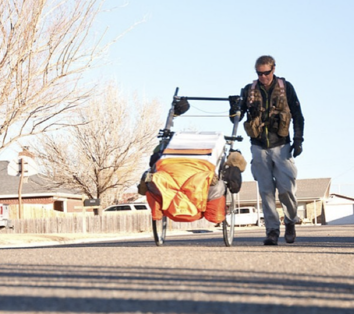 Karl Bushby, who goes for a walk in 1998, pulls his heavy gear cart along a paved road. Karl Bushby, who goes for a walk in 1998, pulls his heavy gear cart along a paved road.