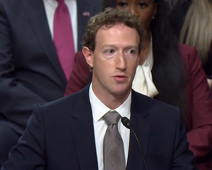 Mark Zuckerberg wearing a suit while discussing bizarre behavior topic. Mark Zuckerberg wearing a suit while discussing bizarre behavior topic.