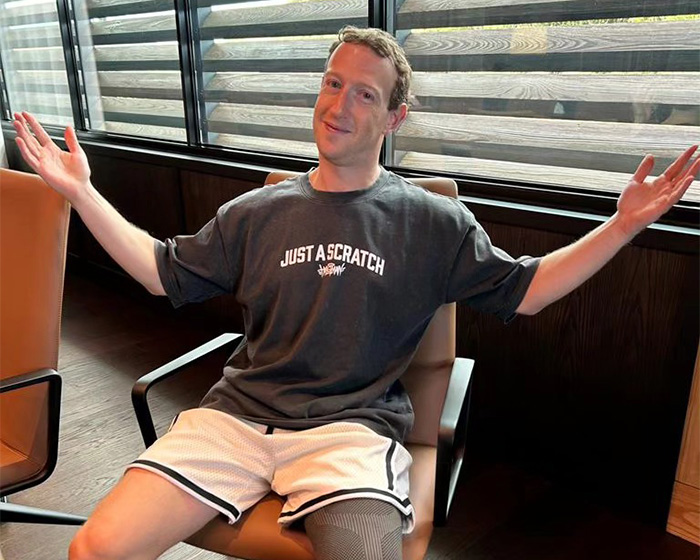 Mark Zuckerberg gesturing with arms open in a casual t-shirt and shorts. Mark Zuckerberg gesturing with arms open in a casual t-shirt and shorts.