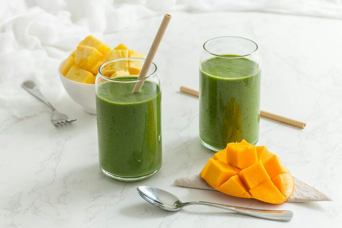 Fresh green smoothies and chopped mango representing food brands consumers refuse to give money to