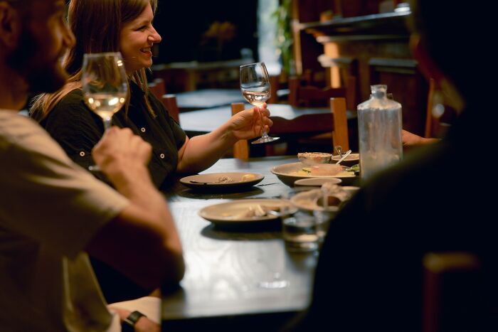 People enjoying wine together during a dining out experience in a European restaurant. People enjoying wine together during a dining out experience in a European restaurant.