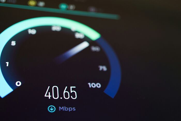 Digital speedometer on a screen showing internet speed test performance for companies behind the scenes.