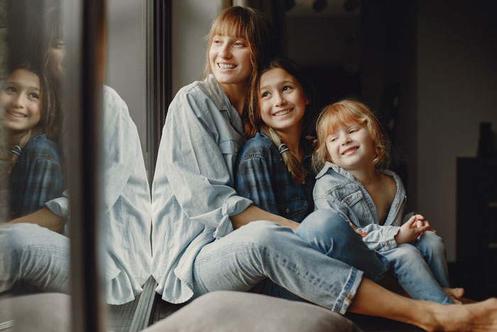 Smiling mother with children by window in MIL accuses epileptic DIL story Smiling mother with children by window in MIL accuses epileptic DIL story