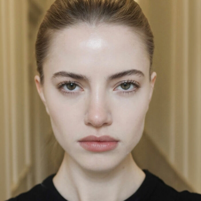 A female model with natural skin posing for a fashion portrait.