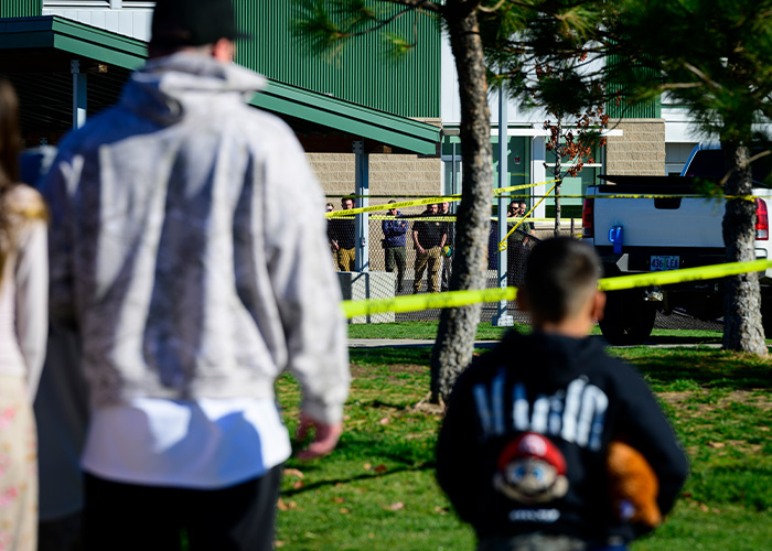 Community members gather near police tape at Oregon elementary school tragedy site