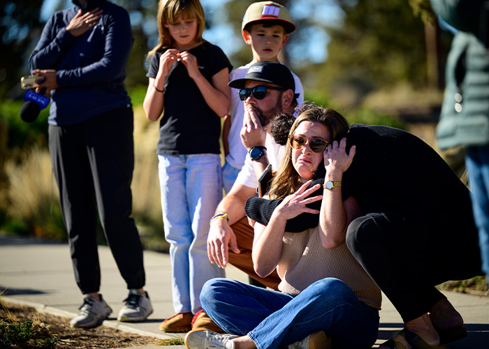 People console each other outside during Oregon elementary school tragedy aftermath