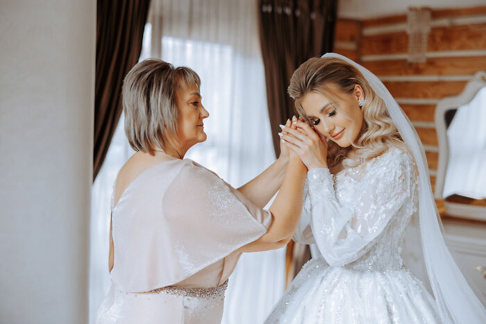 A bride getting ready with her mother before the wedding