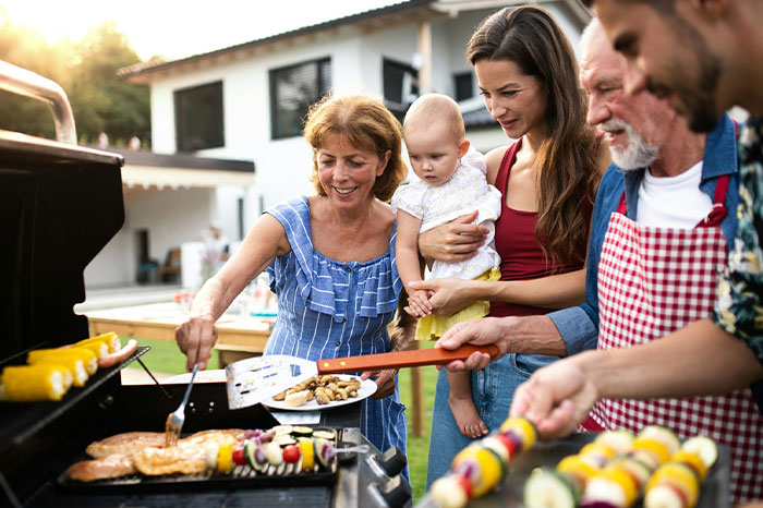 Happy family having a outdoor BBQ dinner representing complex family dynamics.