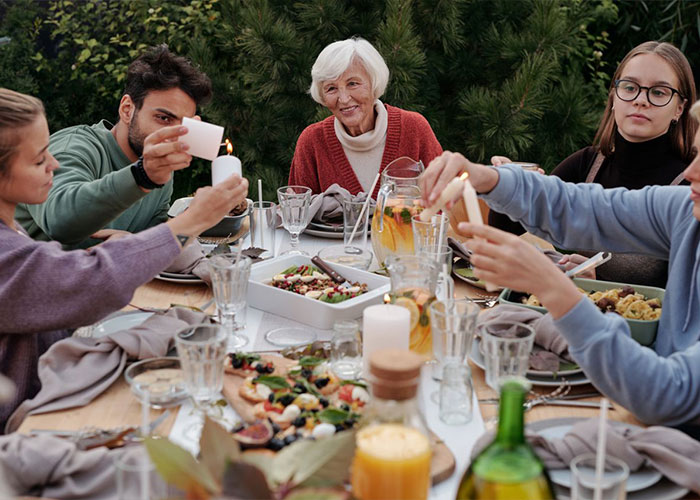 Family gathering dinner outdoors as guy keeps pursuing ex who rejected him.