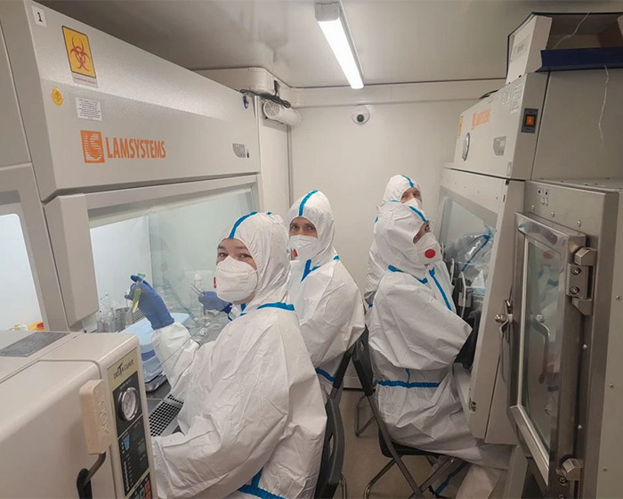 Researchers in full protective gear working in a containment facility, related to suspected plague lab leak. Researchers in full protective gear working in a containment facility, related to suspected plague lab leak.