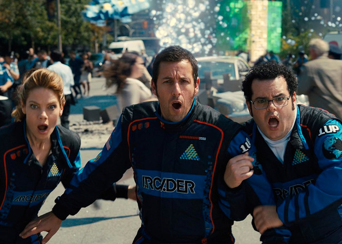 Adam Sandler looking shocked alongside co-stars on a movie set scene