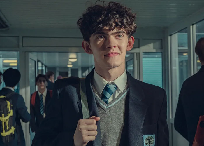 Joe Locke as Charlie Spring in Heartstopper, representing the Hollywood star in school uniform.