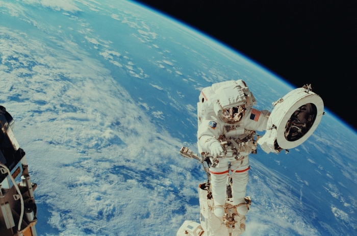 An astronaut on a spacewalk high above Earth, searching for strange objects in our skies An astronaut on a spacewalk high above Earth, searching for strange objects in our skies