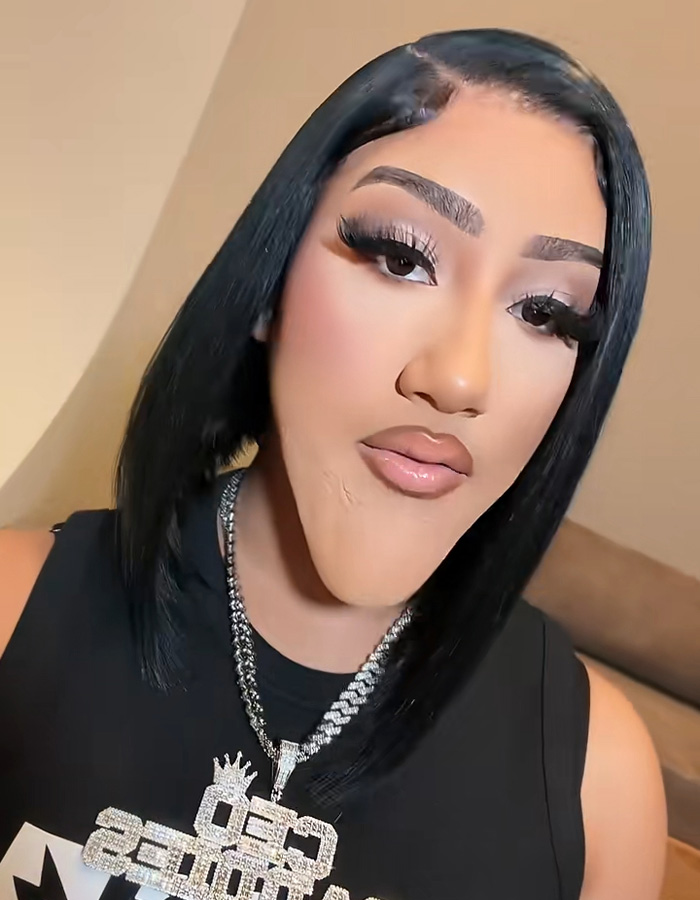 Natalie Nunn wearing a exaggerated prosthetic chin for a viral Halloween transformation.