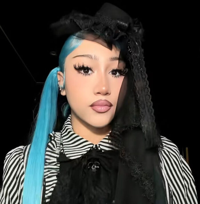 North West showcasing her Halloween transformation with blue hair and dark gothic makeup.