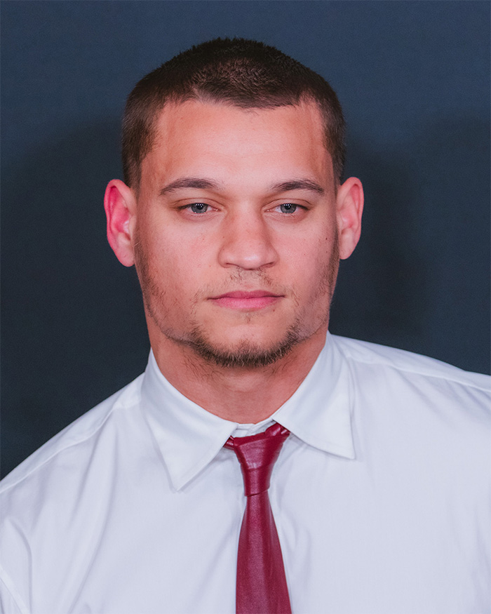 Headshot of young man in white shirt and red tie for a photoshoot context