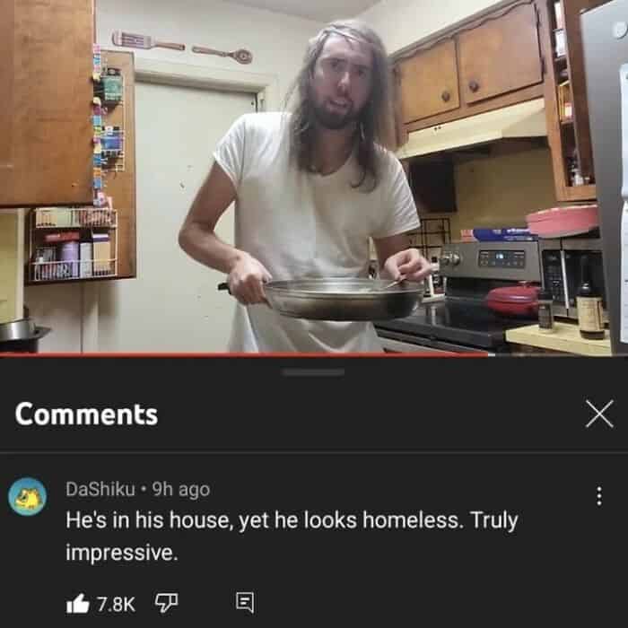 A man holding a pan in a kitchen with funny and oddly accurate insults comment about his appearance below.