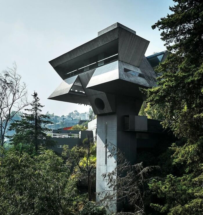 Unique strange building with angular concrete design in forested area