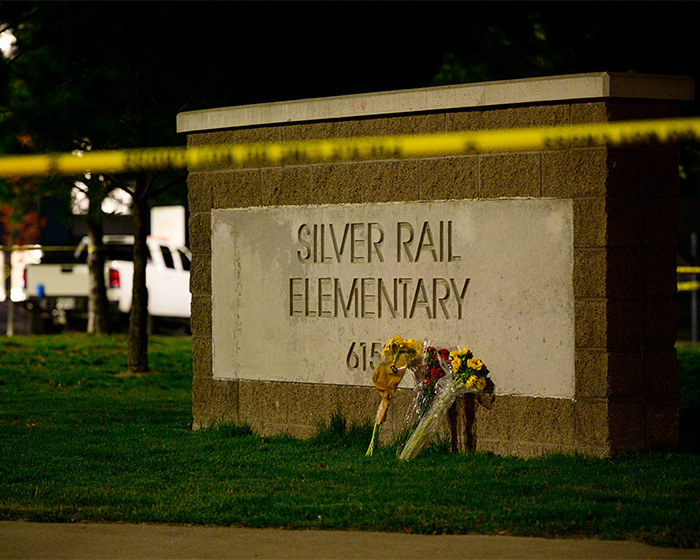 Silver Rail Elementary school sign with flowers and police tape at night Silver Rail Elementary school sign with flowers and police tape at night