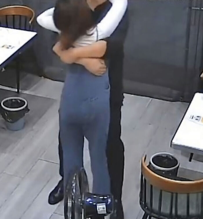 A man giving a tight hug to a woman, relating to the story of a husband breaking his wife's ribs