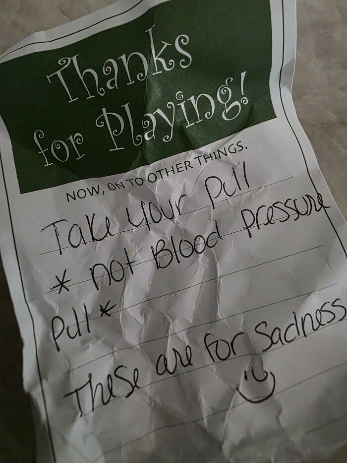 A crumpled found paper note about taking medication and sadness.
