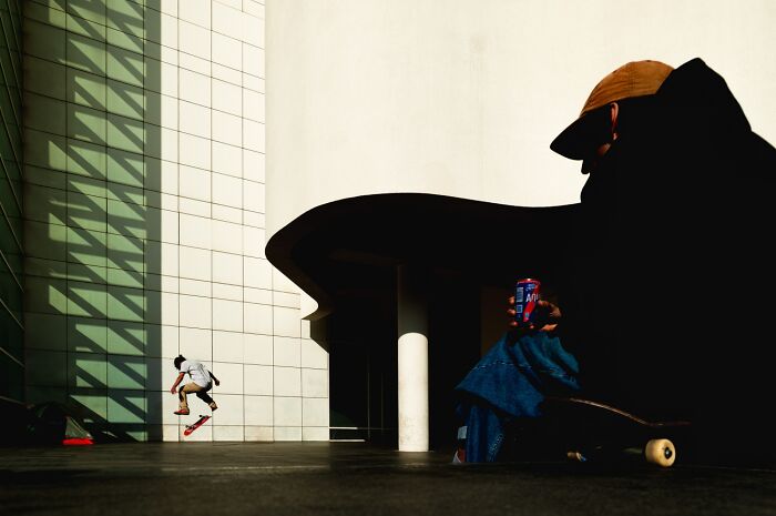 Skateboarder performing trick with dramatic shadows at Siena International Photo Awards