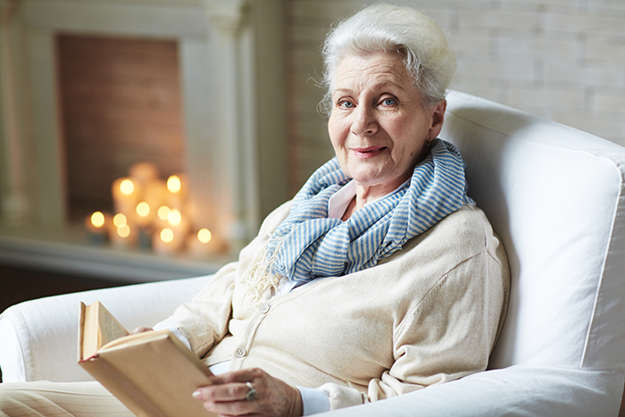 An elderly grandma sitting in a chair, representing family dynamics before giving birth An elderly grandma sitting in a chair, representing family dynamics before giving birth