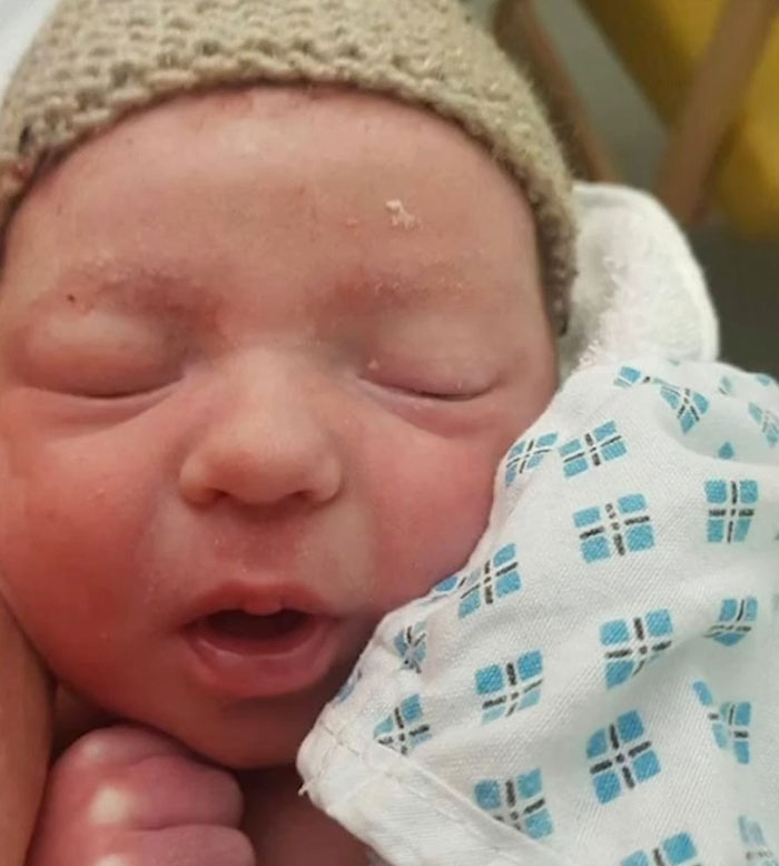 Close-up of a sleeping newborn baby named Lucifer by his parents after a fight with the registrar.