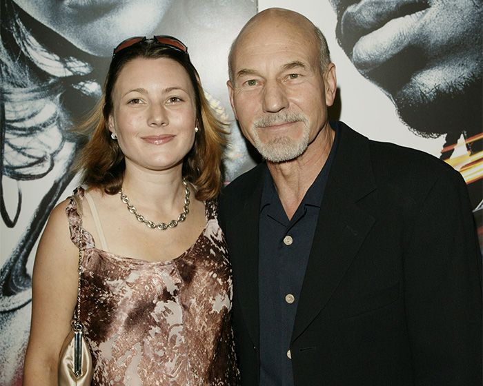 Patrick Stewart poses smiling next to his daughter Sophia Stewart at an event.